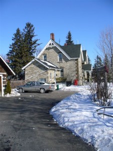 This side view shows the addition as well as the corner log garage Dr. Hartin moved to the site.   Courtesy Joan Darby